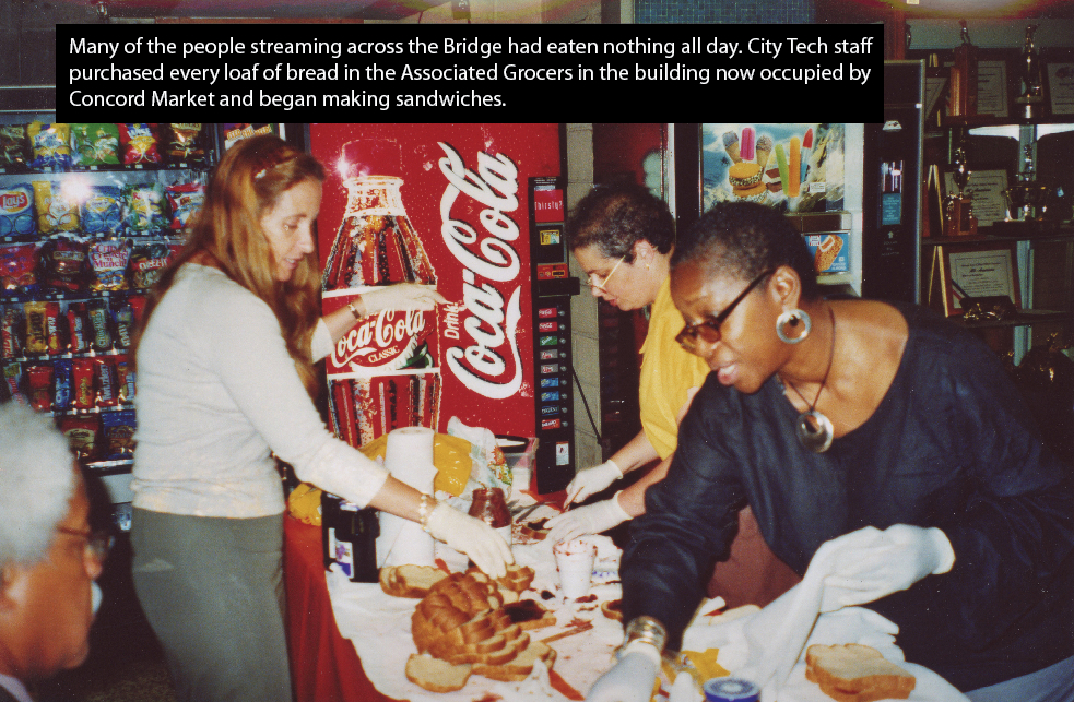 Three people standing near a table spreading jelly on bread