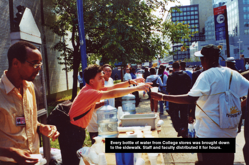 Volunteers set up table out on the sidewalk for distributing water to passerby