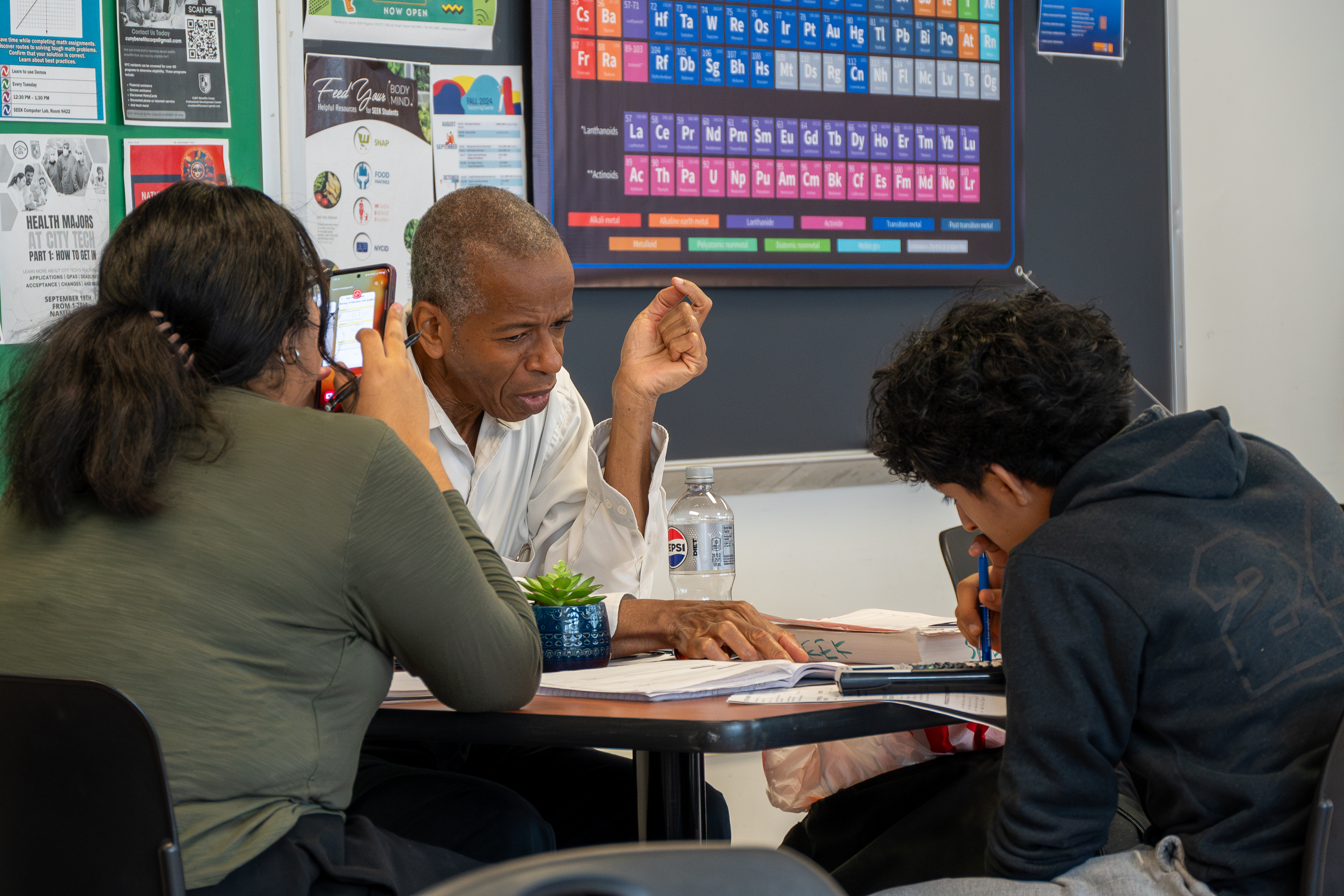 Two students sit at a desk as they receive support from a tutor at the SEEK Center for Learning.